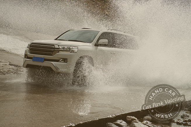 premium car in heavy rain with cpv hand car wash watford logo watermark