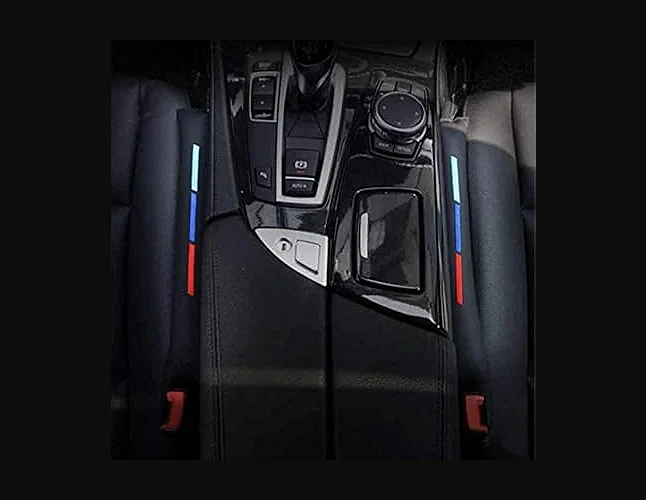 aerial view of twin luxury gap fillers between center console and seats with bmw colours white blue & red for sale at cpv hand car wash watford