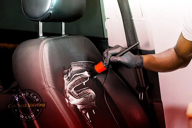 interior car washing with specialized brush and detergent